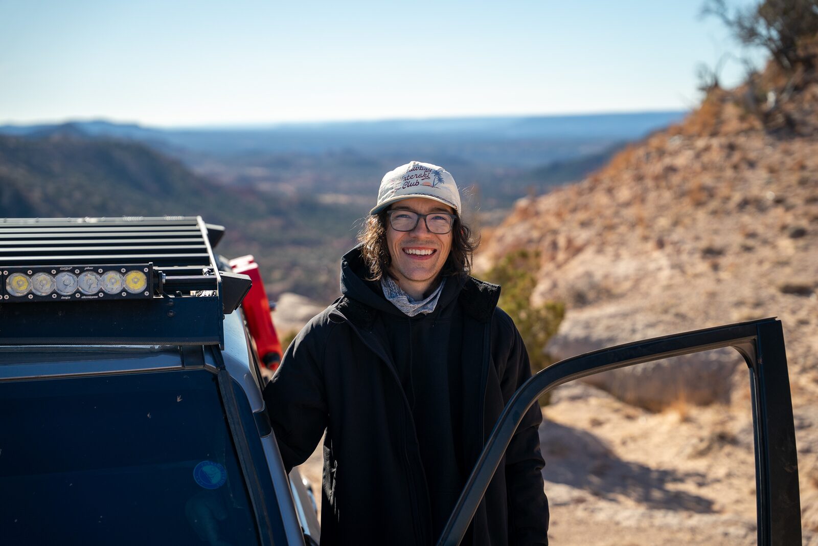 Chris O'Day, founder of Texas Tax Lock, standing by his Land Cruiser at a Texas canyon overlook